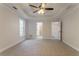 Large bedroom boasts a tray ceiling, ceiling fan, and access to additional rooms at 2346 Hampton Park Dr, Buford, GA 30519