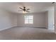 Sizeable bonus room featuring a ceiling fan, a window, and plush carpeting at 2346 Hampton Park Dr, Buford, GA 30519
