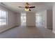 A spacious bonus room with a neutral color palette, plush carpeting and multiple windows at 2346 Hampton Park Dr, Buford, GA 30519