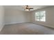 Large bonus room boasts a ceiling fan, a window offering plenty of natural light, and plush carpeting at 2346 Hampton Park Dr, Buford, GA 30519