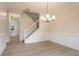 Spacious dining area featuring modern light fixtures, hardwood flooring, and nearby staircase at 2346 Hampton Park Dr, Buford, GA 30519
