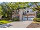 Lovely brick home featuring an attached two-car garage and landscaped front yard at 2346 Hampton Park Dr, Buford, GA 30519