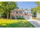 Charming two-story brick home with well-maintained lawn and a two-car garage at 2346 Hampton Park Dr, Buford, GA 30519