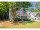 Traditional brick home with blue shutters, a manicured lawn, and lush landscaping at 2346 Hampton Park Dr, Buford, GA 30519