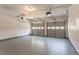 Two-car garage with gray epoxy floor and two garage doors, with windows along the top panel at 2346 Hampton Park Dr, Buford, GA 30519