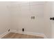 The laundry room has light-colored floors, along with a wire shelf and hookups for the washer and dryer at 2346 Hampton Park Dr, Buford, GA 30519