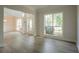 Open-concept living room featuring hardwood floors and views of the foyer and front yard at 2346 Hampton Park Dr, Buford, GA 30519