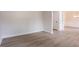 Neutral living room with hardwood floors, base trim, and an adjacent dining area at 2346 Hampton Park Dr, Buford, GA 30519
