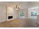 Open-concept living room featuring a fireplace, lots of windows, and modern flooring at 2346 Hampton Park Dr, Buford, GA 30519