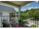 Balcony view with chairs, table, overlooking lush landscaping and neighborhood at 3332 Chastain Landings Ct, Marietta, GA 30066