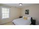 Well-lit bedroom showcasing a neatly made bed, soft carpet, and a bright window at 3332 Chastain Landings Ct, Marietta, GA 30066