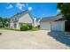 Charming house with detached two-car garage, white siding, and a well-maintained lawn, perfect for suburban living at 3332 Chastain Landings Ct, Marietta, GA 30066