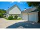 Rear exterior of house with two car garage and driveway at 3332 Chastain Landings Ct, Marietta, GA 30066
