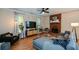 Bright and airy living room with hardwood floors, brick fireplace, and plenty of seating at 3332 Chastain Landings Ct, Marietta, GA 30066