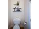 Close-up of a toilet with some decor in a powder room with stylish wallpaper at 3332 Chastain Landings Ct, Marietta, GA 30066