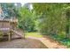 A home's backyard that leads to a wooded area and lush landscaping at 5093 Ravenwood Dr, Marietta, GA 30066