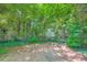 This backyard features a stone firepit, lush landscaping and mature trees at 5093 Ravenwood Dr, Marietta, GA 30066