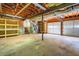 Unfinished basement featuring exposed ducts, a two car garage and built-in shelving at 5093 Ravenwood Dr, Marietta, GA 30066