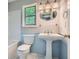 Charming bathroom featuring a pedestal sink, tub with a shower, and blue paneled walls at 5093 Ravenwood Dr, Marietta, GA 30066