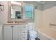 Bathroom features white fixtures, a vanity with storage, and a shower-tub combo at 5093 Ravenwood Dr, Marietta, GA 30066