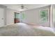 Bright, carpeted bedroom with a large window, ceiling fan, and closet at 5093 Ravenwood Dr, Marietta, GA 30066