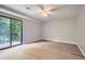 This bedroom has a sliding glass door to a private deck and wood-look floors at 5093 Ravenwood Dr, Marietta, GA 30066