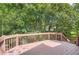A wooden deck overlooking mature trees and lush green landscaping at 5093 Ravenwood Dr, Marietta, GA 30066