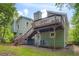 Back exterior of a home featuring a deck and backyard landscaping at 5093 Ravenwood Dr, Marietta, GA 30066