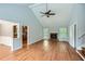 Open-concept living room with vaulted ceiling, hardwood floors, stone fireplace, and modern ceiling fan at 5093 Ravenwood Dr, Marietta, GA 30066