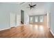 Spacious living room with vaulted ceilings, hardwood floors, large windows, and a modern ceiling fan at 5093 Ravenwood Dr, Marietta, GA 30066