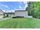A lush, green backyard and tidy landscaping offer a private retreat with mature trees at 609 Bedford Court, Woodstock, GA 30188