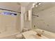 Well-lit bathroom with white tile shower and modern vanity at 609 Bedford Court, Woodstock, GA 30188