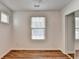 Bedroom with hardwood floors, closet with mirrored doors, and bright window at 609 Bedford Court, Woodstock, GA 30188