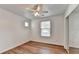 Bright bedroom with hardwood floors, a ceiling fan, and closet with mirrored doors at 609 Bedford Court, Woodstock, GA 30188