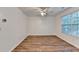 Cozy bedroom features hardwood floors, ceiling fan, and bright window at 609 Bedford Court, Woodstock, GA 30188