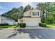 Charming two-story home with a two-car garage, manicured lawn and mature trees at 609 Bedford Court, Woodstock, GA 30188