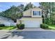 Charming two-story home with a two-car garage, manicured lawn and mature trees at 609 Bedford Court, Woodstock, GA 30188