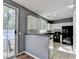 View of kitchen with modern cabinets and appliances with a sliding glass door at 609 Bedford Court, Woodstock, GA 30188
