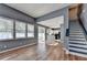 Bright living room with hardwood floors, large windows, and an open floor plan leading to the kitchen at 609 Bedford Court, Woodstock, GA 30188