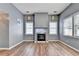 Cozy living room features a fireplace, hardwood floors, and natural lighting at 609 Bedford Court, Woodstock, GA 30188
