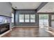 Spacious living room with modern fireplace, hardwood flooring, and backyard patio access at 609 Bedford Court, Woodstock, GA 30188