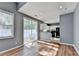 Living room with hardwood floors and a sliding glass door that lets in ample natural light and connects to the kitchen at 609 Bedford Court, Woodstock, GA 30188