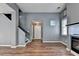 View of the living room, featuring hardwood floors, a staircase, and a front door at 609 Bedford Court, Woodstock, GA 30188