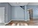 Open living room with hardwood floors and light gray walls at 609 Bedford Court, Woodstock, GA 30188