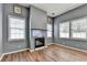 Modern living room with sleek fireplace, hardwood flooring, and natural light at 609 Bedford Court, Woodstock, GA 30188