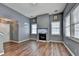 Spacious living room showcasing a modern fireplace, hardwood floors, and natural light from multiple windows at 609 Bedford Court, Woodstock, GA 30188