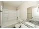 This is a well-lit bathroom with a shower-tub combo, white tile, and granite countertop vanity at 1112 Smith St, Atlanta, GA 30310
