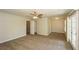 Open bedroom showing a neutral wall color, ceiling fan, carpet, access to a balcony, and an en-suite bathroom at 1112 Smith St, Atlanta, GA 30310