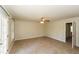 Spacious bedroom with neutral walls, carpet floors, and French doors leading to a balcony at 1112 Smith St, Atlanta, GA 30310