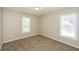 This is a cozy bedroom featuring natural light and neutral walls with plush carpet at 1112 Smith St, Atlanta, GA 30310